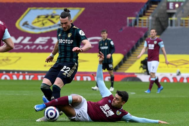Jack Harrison is challenged by Burnley's Matthew Lowton. Picture: Simon Hulme.