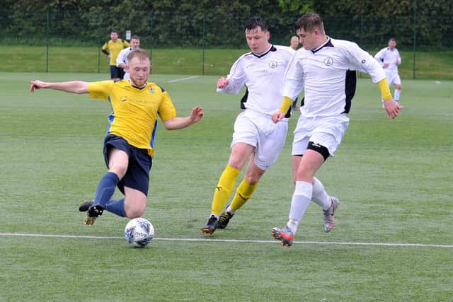 Matthew Jackson, of Gildersome Spurs OB, is first to the ball during Saturday's Yorkshire Amateur Premier defeat to visiting Nostell MW. Picture: Steve Riding.