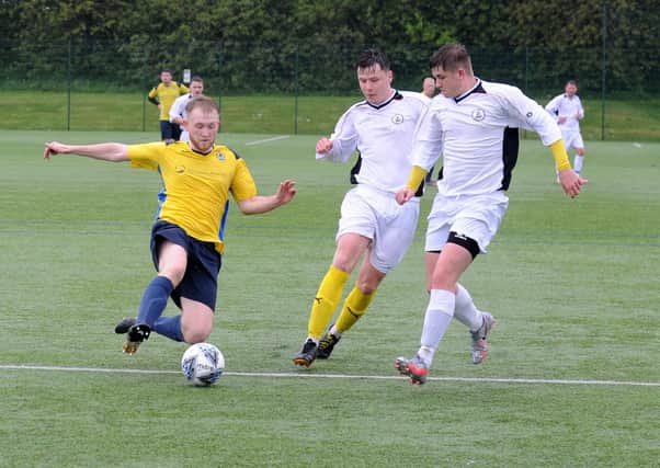 Matthew Jackson, of Gildersome Spurs OB, is first to the ball during Saturday's Yorkshire Amateur Premier defeat to visiting Nostell MW. Picture: Steve Riding.