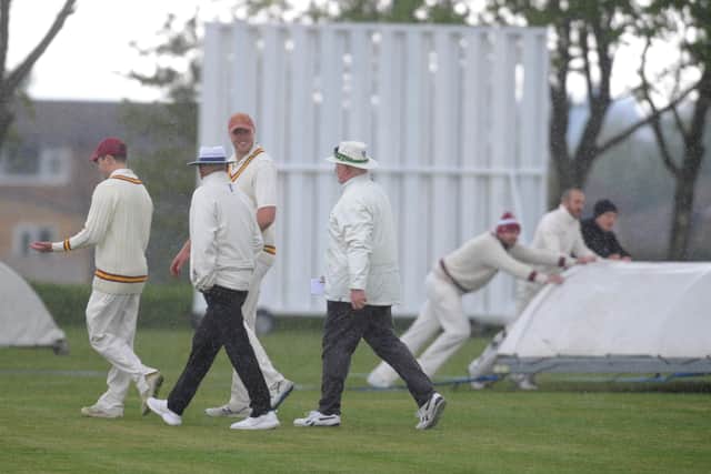 The umpires bring the players off for rain at Morley with the home side batting at 12-2 against Methley. The game never resumed. Picture: Steve Riding.
