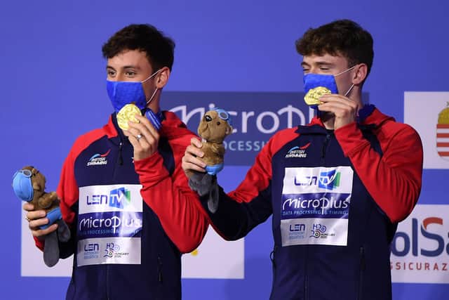 Gold medallists Great Britain's Matthew Lee (L) and Great Britain's Thomas Daley pose on the podium . (Picture: Attila KISBENEDEK / AFP) (Photo by ATTILA KISBENEDEK/AFP via Getty Images)