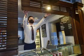 Gary Benn, manager of Cottage Road Cinema brings up the shutters for reopening. Picture: Steve Riding.