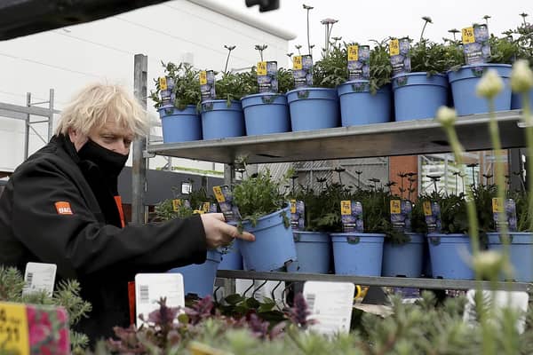 Prime Minister Boris Johnson chooses a plant as he visits the garden centre in the B&Q store in Middlesbrough.