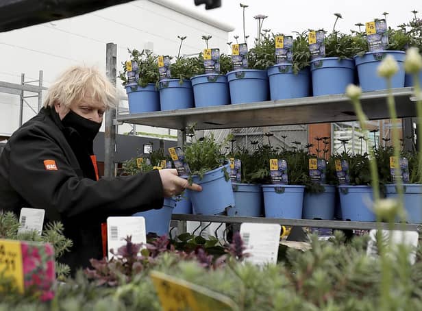 Prime Minister Boris Johnson chooses a plant as he visits the garden centre in the B&Q store in Middlesbrough.