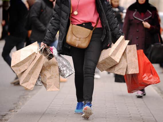 Library image of a woman carrying shopping