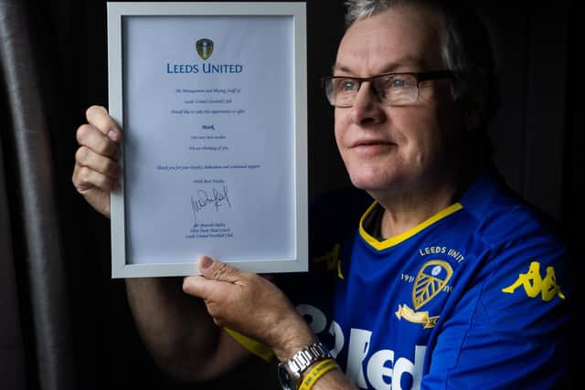 Leeds United fan Mark White with the message signed by club manager Marcelo Bielsa. Picture: James Hardisty