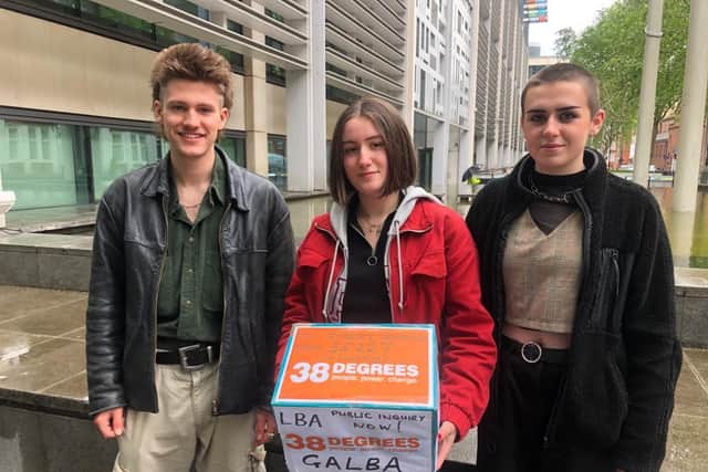 Brannoc Stevenson, Naomi Simpson and Martha Dacombe hand the petition in.