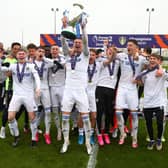 THE FUTURE: Captain Charlie Cresswell and the rest of the Leeds United under-23s team celebrate getting their hands on the Premier League 2 Division Two title winners' trophy. Picture by LUFC.