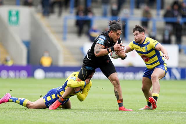 TOUGH DAY: Castleford Tigers' Jesse Sene-Lefao is tackled by Warrington Wolves' Gareth Widdop and Joe Philbin. Picture by Paul Currie/SWpix.com.