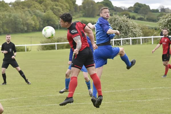 Ash Atkinson, right of Boroughbridge, heads on past Horbury Town defender James Smith during Saturday's Premier encounter. Picture: Steve Riding.