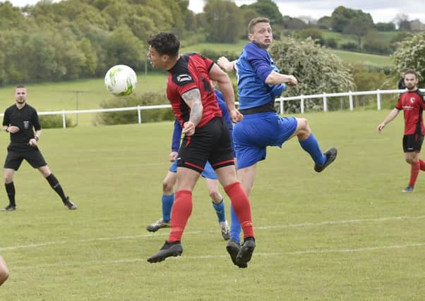 Ash Atkinson, right of Boroughbridge, heads on past Horbury Town defender James Smith during Saturday's Premier encounter. Picture: Steve Riding.