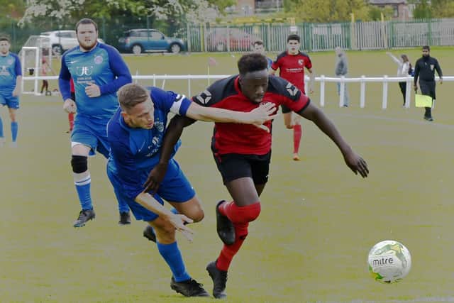 Ash Atkinso, of Boroughbridge, tries to stop Horbury Town's Gibril Bojang. Picture: Steve Riding.