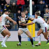 Corey Johnson, with ball, featured for Rhinos in their 2019 Boxing Day clash with Wakefield Trinity. Picture by Steve Riding.