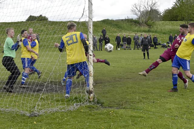 Thomas Boocock , right, scores for Norristhorpe Rangers in the 2-0 win at Stanningley OB. Picture: Steve Riding.