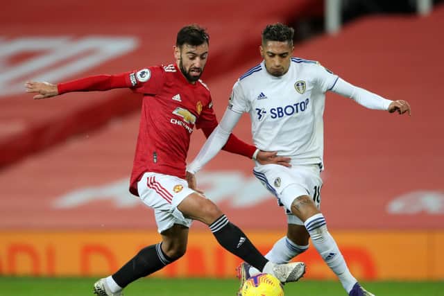 RIVAL FRIENDS: Leeds United winger Raphinha, right, and Manchester United's Bruno Fernandes, left, in December's Premier League clash at Old Trafford. The duo were team mates at Sporting Lisbon. Photo by Nick Potts - Pool/Getty Images.