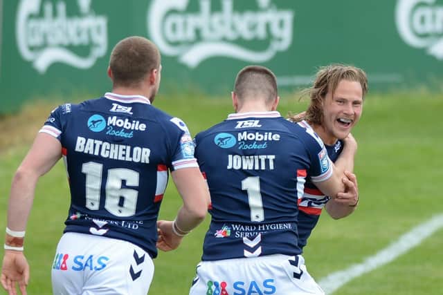 BACK ON TRACK: Wakefield Trinity's Jacob Miller celebrates his try with Max Jowitt and James Batchelor during the win over Hull KR. Picture courtesy of Dean Williams