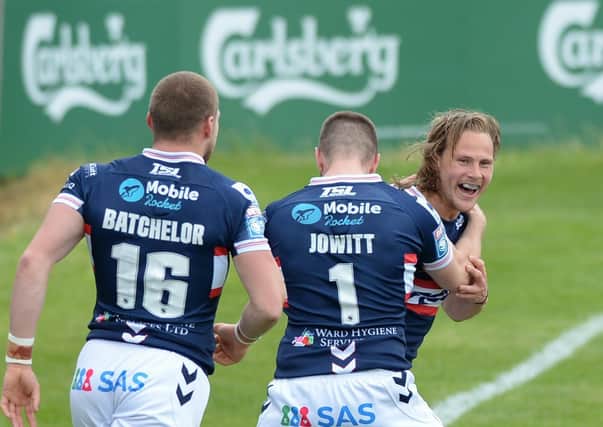 BACK ON TRACK: Wakefield Trinity's Jacob Miller celebrates his try with Max Jowitt and James Batchelor during the win over Hull KR. Picture courtesy of Dean Williams