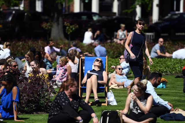 Stock image - people enjoy the sun in Park Square in Leeds (photo: Jonathan Gawthorpe)