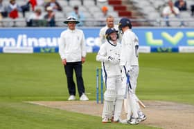 Well done: Harry Duke, left, is congratulated on his Roses half-century by Yorkshire captain Steve Patterson. Picture: John Heald