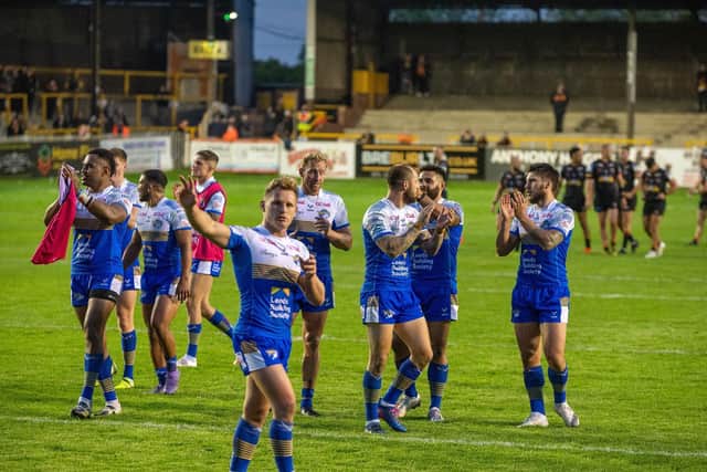 Rhinos players thank their fans after the win at Castleford. Picture by Bruce Rollinson.