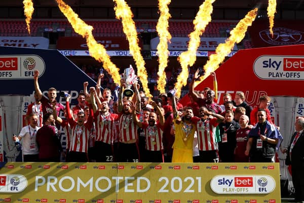Brentford captain Pontus Jansson lifts Championship play-off final trophy at Wembley. Pic: Getty