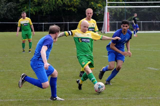 Daniel Chadwick, of Middleton, gets in a foot during Saturday's Premier encounter at Ealandians. Picture: Steve Riding.