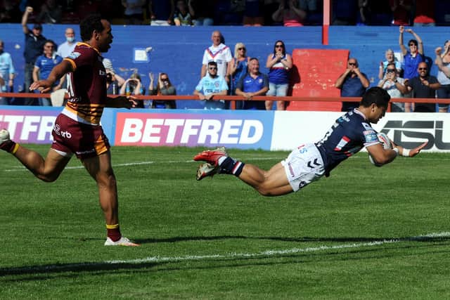 Wakefield Trinity's Mason Lino dives in for his side's seventh and final try in the win over Huddersfield Giants. Picture: Simon Hulme/JPIMedia.
