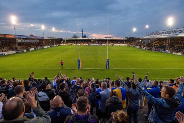 Leeds Rhinos fans celebrate in the Railway End at Wheldon Road last Friday.  Picture: Bruce Rollinson.