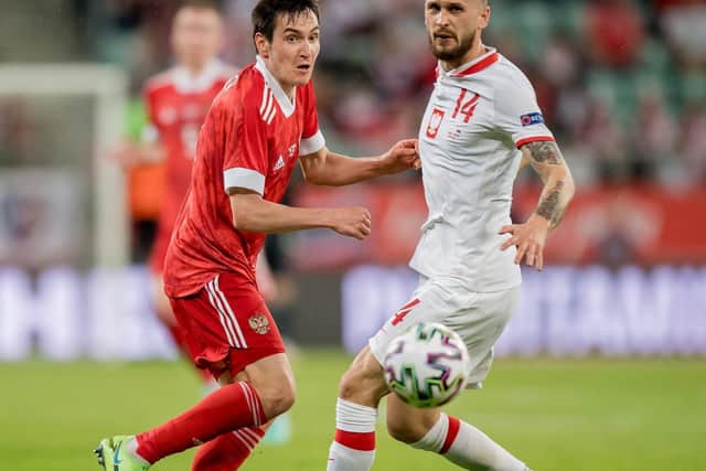 ARCHITECT: Leeds United's Mateusz Klich, right, in Poland's 1-1 draw against Russia, pictured as the Whites midfielder locks horns with Vyacheslav Karavaev. Photo by Thomas Eisenhuth/Getty Images.