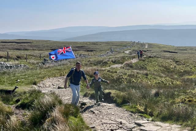 Little Jacob Newson, 7, climbed Ingleborough, Whernside and Pen-y-Ghent in the Yorkshire Dales in just under five hours - in memory of his mother who died of breast cancer six months ago (photo: Andrew Newson / SWNS.COM)