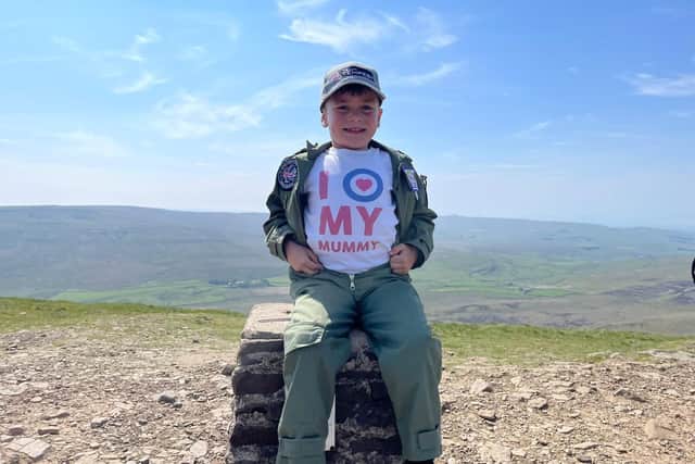 Little Jacob Newson, 7, climbed Ingleborough, Whernside and Pen-y-Ghent in the Yorkshire Dales in just under five hours - in memory of his mother who died of breast cancer six months ago (photo: Andrew Newson / SWNS.COM)