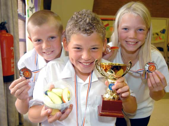 Kalvin pictured alongside Whingate Primary School classmates Peter Hogan and Kirsten Richards in 2007.