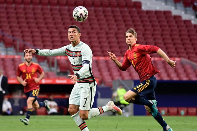 BACK IN ACTION: Leeds United centre-back Diego Llorente, right, chasing Portugal's Cristiano Ronaldo in Friday night's friendly in Madrid. Photo by JAVIER SORIANO/AFP via Getty Images.