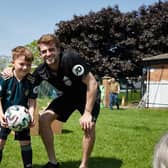 Leeds United striker Patrick Bamford with a young fan during his visit to Beeston Juniors. Pic: Leeds United