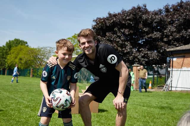 Leeds United striker Patrick Bamford with a young fan during his visit to Beeston Juniors. Pic: Leeds United