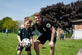 Leeds United striker Patrick Bamford with a young fan during his visit to Beeston Juniors. Pic: Leeds United