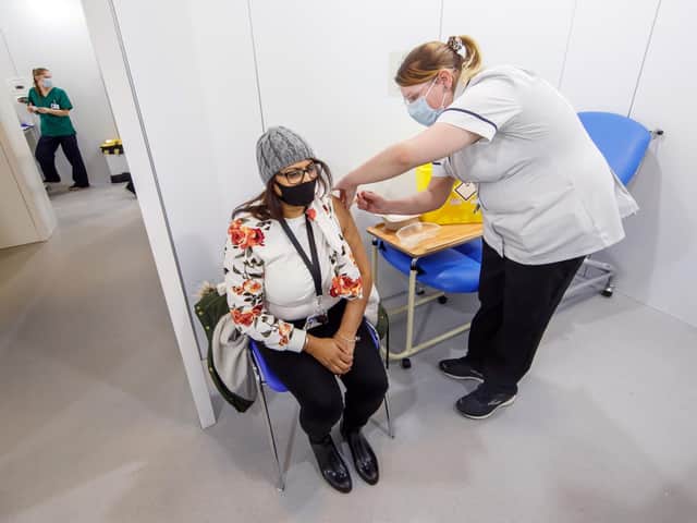 A woman receives an injection of the the Oxford/AstraZeneca coronavirus vaccine at Elland Road vaccine centre in Leeds (photo: PA Wire/ Danny Lawson)