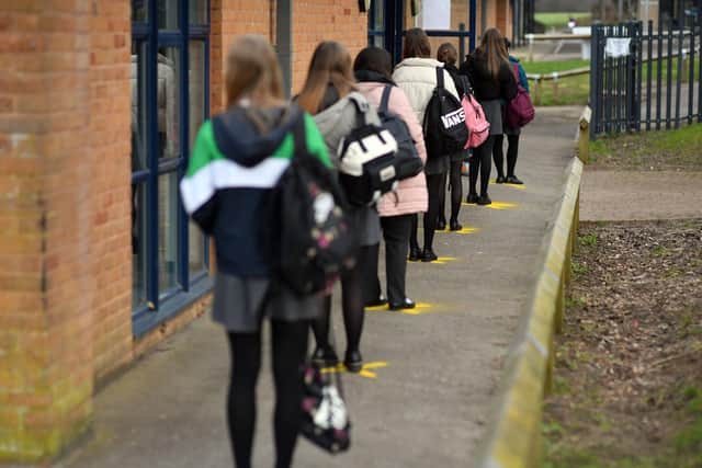 School pupils line up to take lateral flow tests.