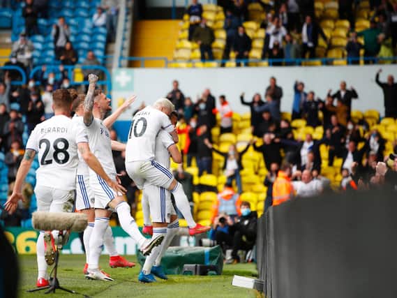 Leeds United players celebrate with fans at Elland Road. Pic: Getty