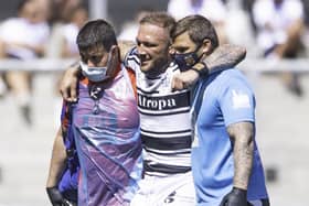 Hull FC's Josh Griffin is helped from the pitch after snapping his Achilles tendon during last Saturday's Challenge Cup semi-final against St Helens. Picture: Allan McKenzie/SWpix.com.