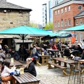 Pictured: Friends enjoying food and drink outside at Water Lane Boathouse, one of many fantastic venues in Leeds.