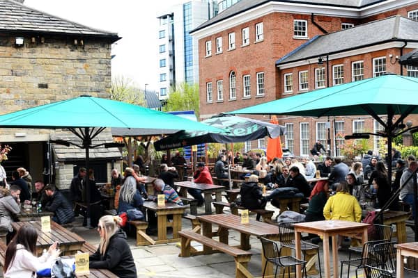Pictured: Friends enjoying food and drink outside at Water Lane Boathouse, one of many fantastic venues in Leeds.