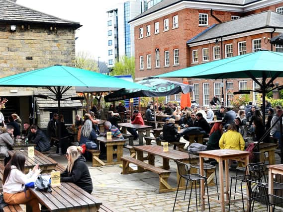 Pictured: Friends enjoying food and drink outside at Water Lane Boathouse, one of many fantastic venues in Leeds.