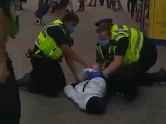 Police officers were pictured pinning down a man in Leeds city centre on Monday in video circulated online.