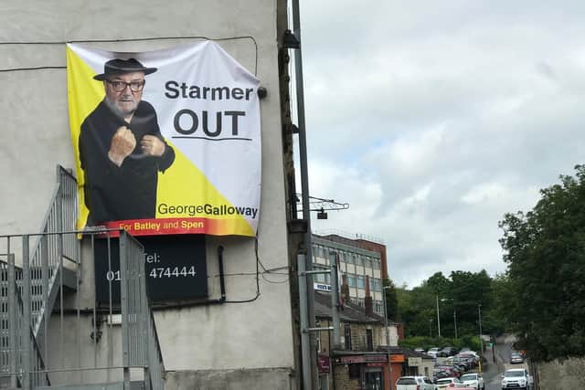 A huge poster showing George Galloway, fists raised in a boxing pose, with the slogan: ‘Starmer Out’