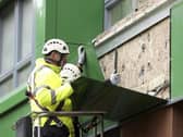 A workman in Sheffield replacing cladding. (Pic: SWNS)