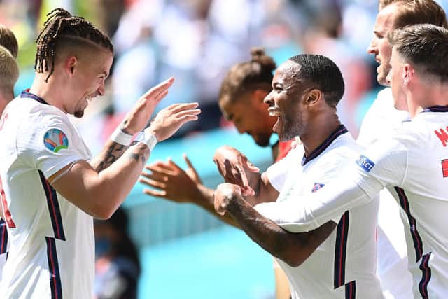 HELPING HAND: Leeds United midfielder Kalvin Phillips, left, celebrates with goal scorer Raheem Sterling, right, after setting up the England opener. Photo by GLYN KIRK/POOL/AFP via Getty Images.
