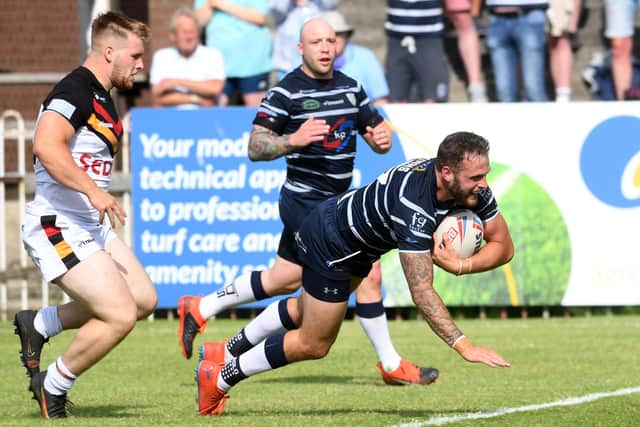 Thomas Minns dives in for a try for Featherstone Rovers against Bradford Bulls. Picture: Simon Hulme/JPIMedia.