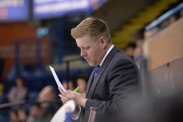 Pete Russell writes down notes on the GB bench during a game. picture: Dean Woolley.
