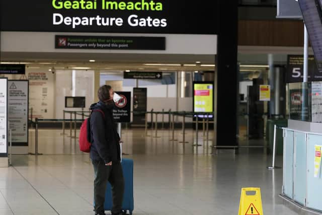 File photo dated of a man wearing a protective face mask in the departures area of terminal one at Dublin airport. Aer Lingus has announced details of a replacement flights schedule after operator Stobart Air ended its contract with the Irish airline.